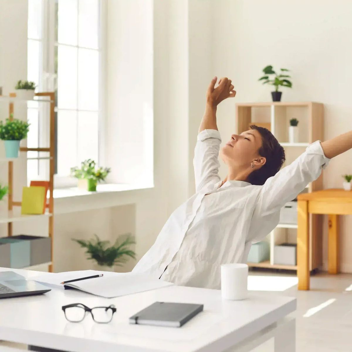 Person practising a calm breathing exercise at a desk after finishing work tasks